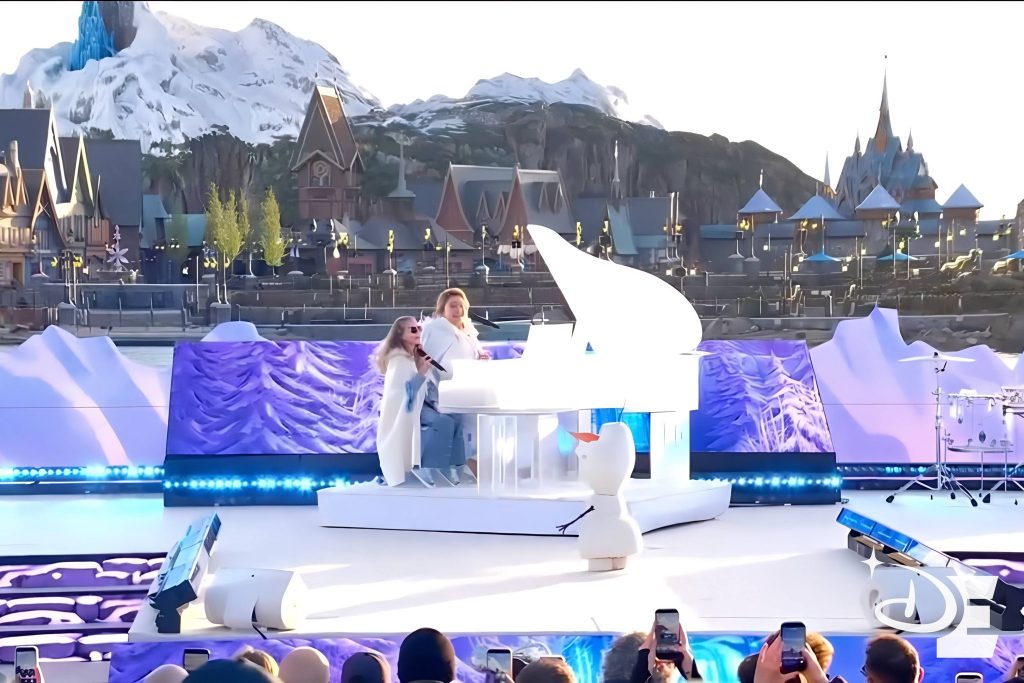 Lou avec Santa chantent pour l'inauguration du Monde de La Reine des Neiges. 